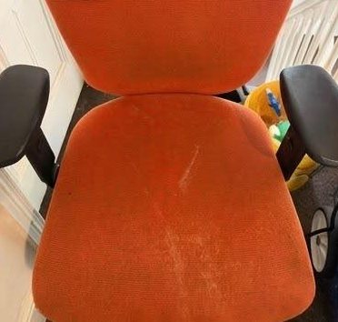 Before: orange fabric office chair with pale marks and spills on the seat