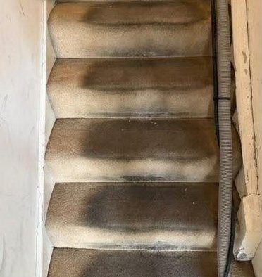 Before: beige stair carpet with dark grey traffic marks across every step